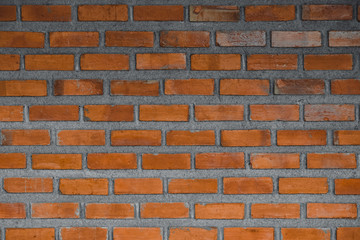 Red brick wall fragment background or brick layer building texture.