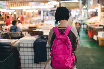 traveling woman in the traditional marketplace