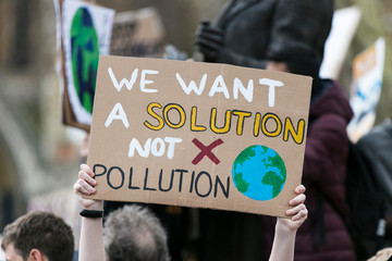 People with banners protest as part of a climate change march