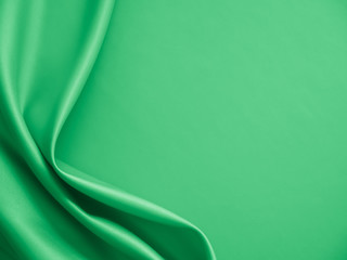 Beautiful smooth elegant wavy light green satin silk luxury cloth fabric texture, abstract...