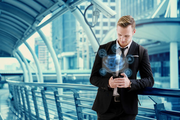 Caucasian Businessmen are standing in city Hand holding a smartphone 5G network to communicate with people in digital business online Internet technology in everything Making work orders from anywhere