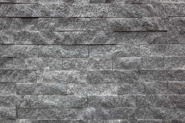 gray brick wall with rough texture