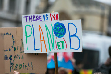 People with banners protest as part of a climate change march