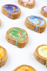 Delicious creamy colourful minimal cake roll on white background.