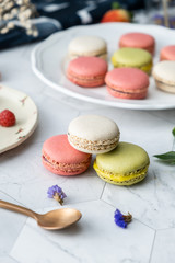 Macaron or French macaroon cookies dessert. Set on cafe table.