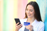 Happy buyer pays on line with credit card and phone