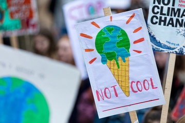 People with banners protest as part of a climate change march