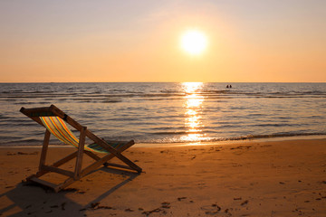 Beach chair on the tropical beach at sunset time