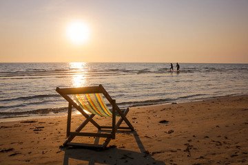 Beach chair on the tropical beach at sunset time