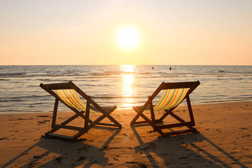 Beach chair on the tropical beach at sunset time