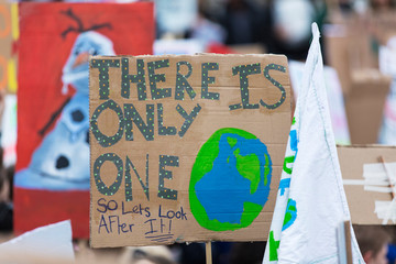 People with banners protest as part of a climate change march