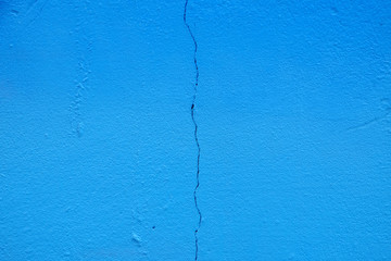 blue paint wall background with crack