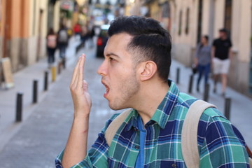 Man checking his own breath