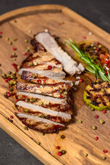 Sliced meat. Grilled beef steak on wooden cutting board. Grilled meat.