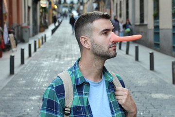 Man with a very long nose outdoors