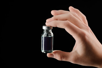 Hand holding a vial