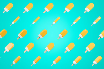 Pattern made of flying glossy  yellow  lolly ice cream on the blue background.