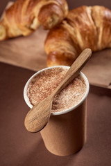 Delicius coffee in ecological, paper cup, wooden spoon