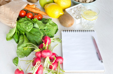 Blank notebook and lot of vegetables, fruits. Concept of healthy lifestyle, meal planning and good purchase
