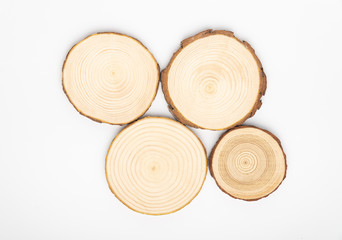 Pine tree cross-sections with annual rings on white background. Lumber piece close-up shot, top...