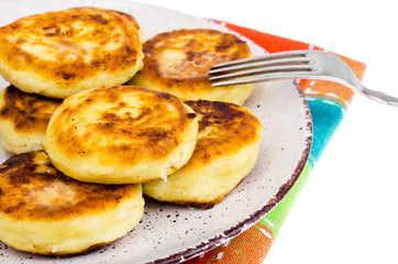 Hot tasty curd cheesecakes on plate.