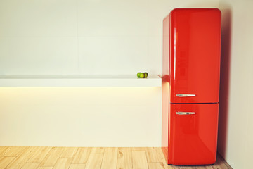 Red refrigerator on a white background with apples.