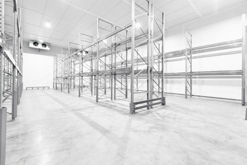 monochrome Interior of empty warehouse with empty racks