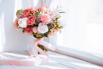 Wedding flowers, bridal bouquet closeup. Decoration made of roses, peonies and decorative plants, close-up, white background