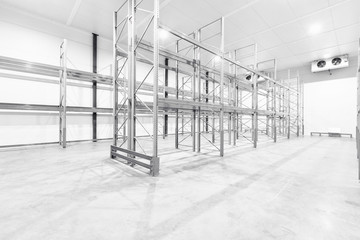 monochrome Interior of empty warehouse with empty racks