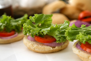 Making cheese burger with grilled beef and bacon.