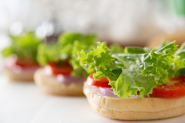 Making cheese burger with grilled beef and bacon.