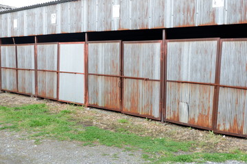 Rusted garage with green grasses