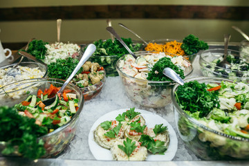 Greek food background. Greek salad, assortment of feta, olives and vegetables. Traditional greek dishes set.