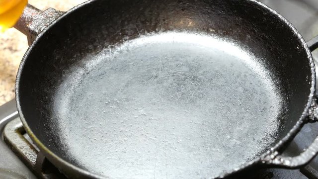vegetable oil poured on a hot pan, close-up