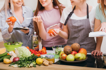 Culinary courses. Communication and food education. Women choosing organic vegetables and learning...