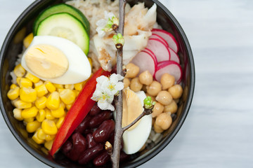 Bowl with vegetables, rice and fish.