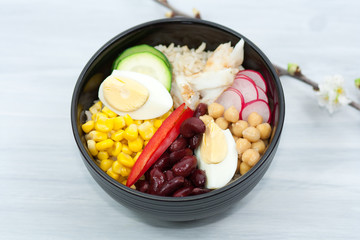 Bowl with vegetables, rice and fish.