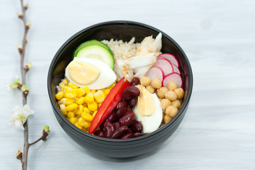 Bowl with vegetables, rice and fish.  Healthy food concept.