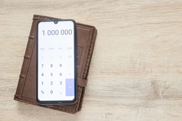 organizer with   open calculator with numbers 1 000 000  on the background of a desk with copy space