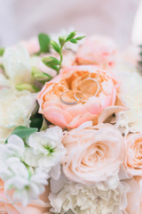 Wedding rings closeup on the bouquet of the bride