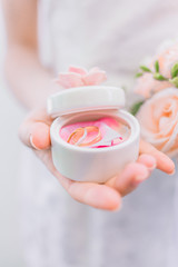 The bride holds a box with wedding rings
