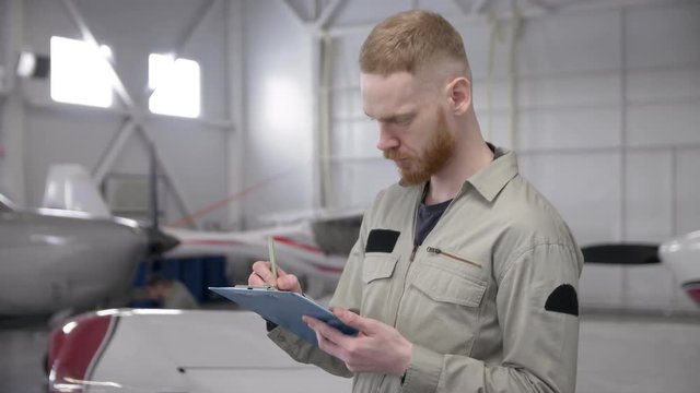 Airplane technician checking serviceability of airplane