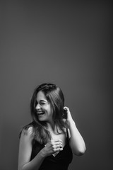 Young woman with toothy smile. Happiness and euphoria. Laughing with eyes closed. Black and white...