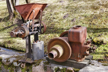 Fototapeta na wymiar Rusty vintage small tractors diesel engines and retro machinery in village