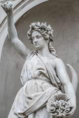 Statue of sensual busty and puffy renaissance era woman in circlet of flowers, Potsdam, Germany, details, closeup