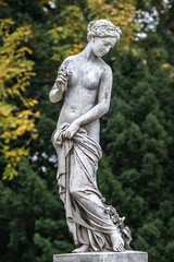 Statue of sensual naked Greek renaissance era woman with flowers, Potsdam, Germany, details, closeup