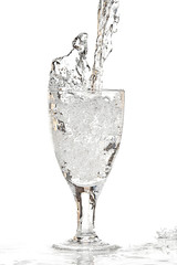 clear water splashing into transparent glass