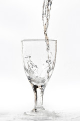 clear water splashing into transparent glass