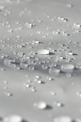 transparent sparkling water drops on white sheet