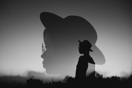 Double exposure photo with female silhouette. Freedom and travel concept. Close up head and hat